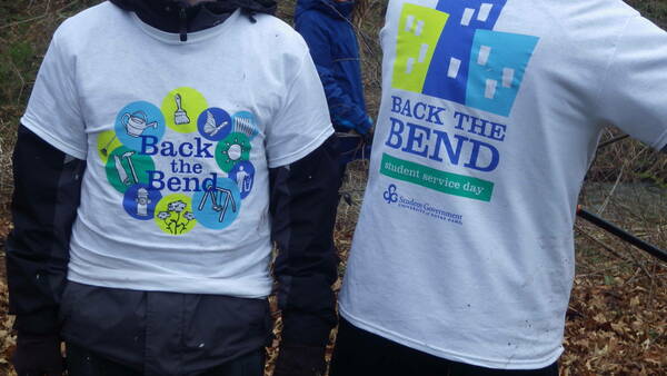 two people wearing Back the Bend t-shirts